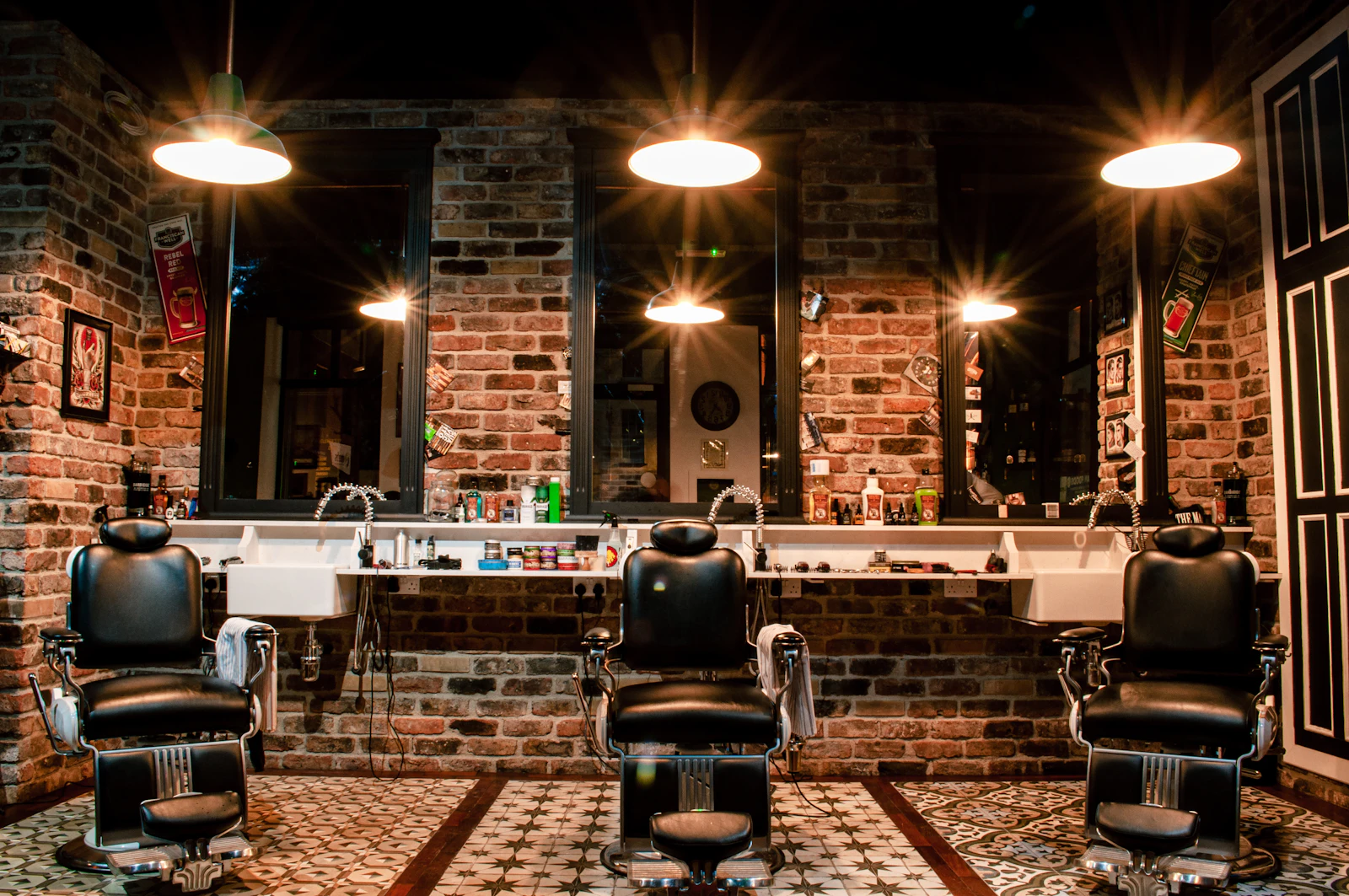 Traditional barber chairs in a brick-lined shop; illustrative stock interior, not Alpha Cuts premises