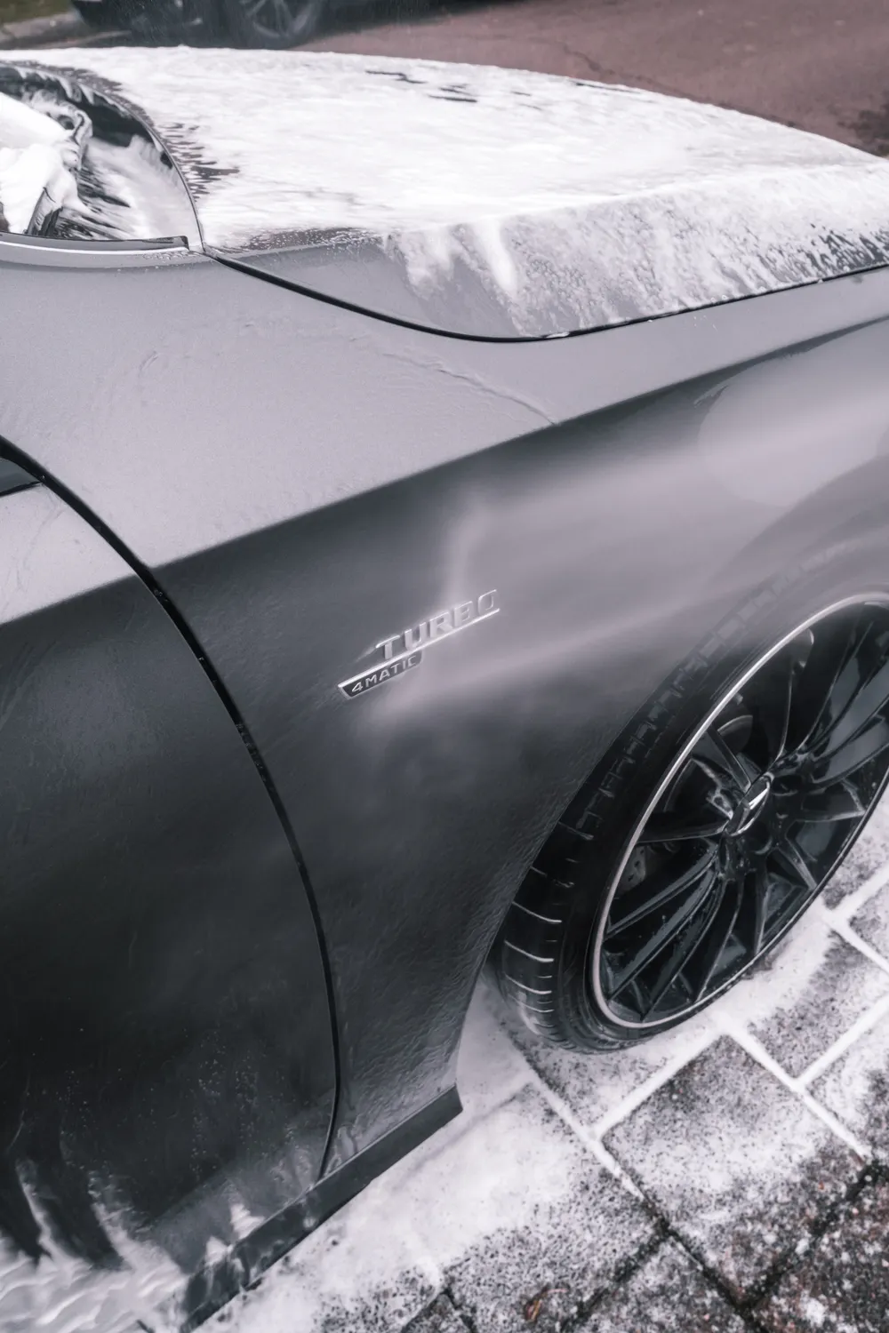 Illustrative stock photo: foam and water on a car during a wash